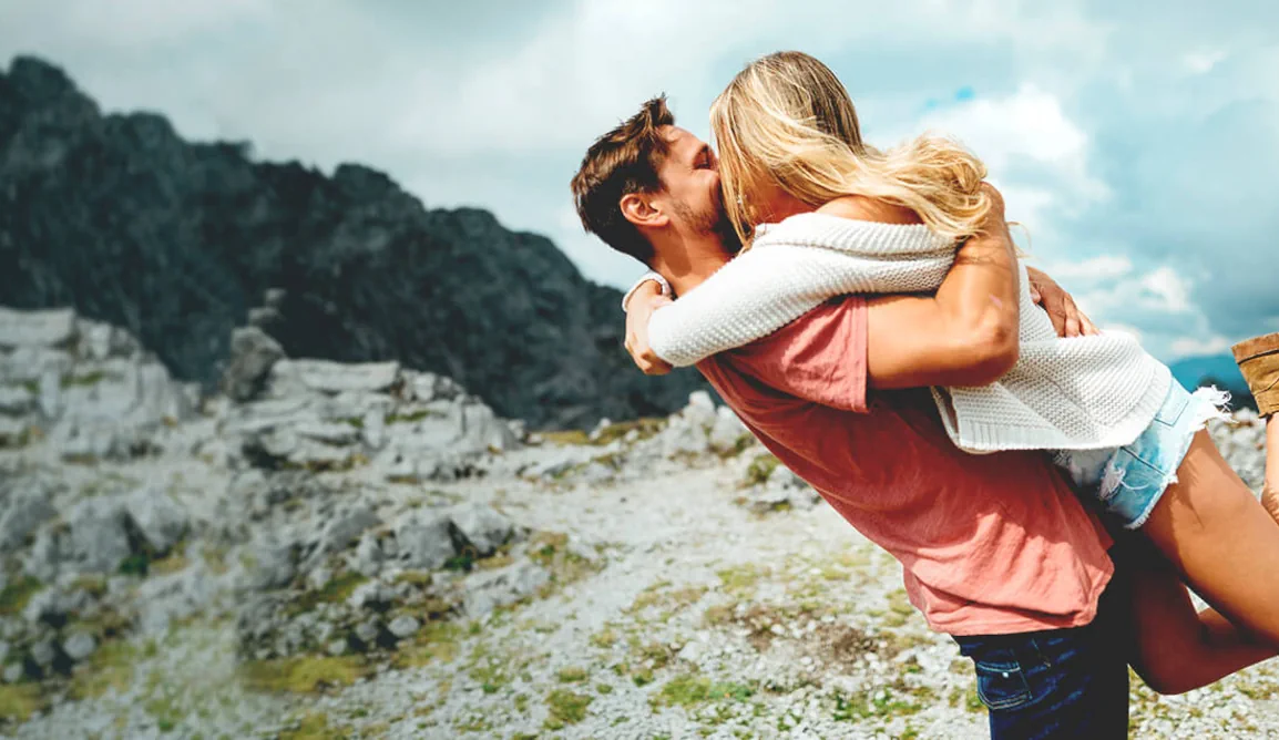 Couple celebrating love on a mountain top